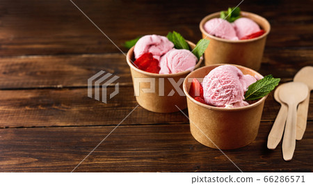 Strawberry ice cream in recycled craft paper cups 66286571