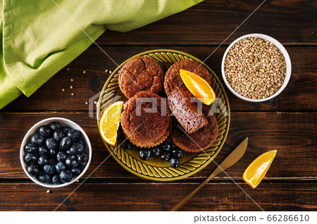 Gluten-free vegan buckwheat muffins on dark wooden table 66286610