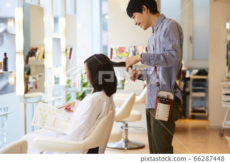 Hairdresser Young male hairdresser doing a cut 66287448