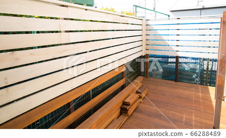 In the middle of making a wood deck in the garden 66288489