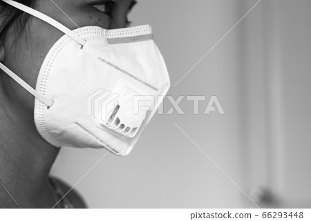 Asian woman using mask protect PM 2.5 because pollution in home,Young female got nose allergy,Black and white toned 66293448