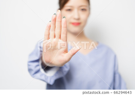 Young woman making an NG gesture 66294643