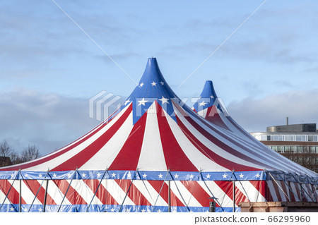 Red and white circus tent topped with bleu starred 66295960