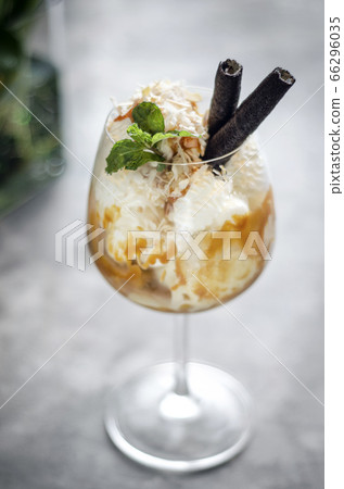 coconut and caramel ice cream sundae dessert in 66296035