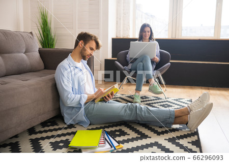 Young couple spending the day at home studying together 66296093