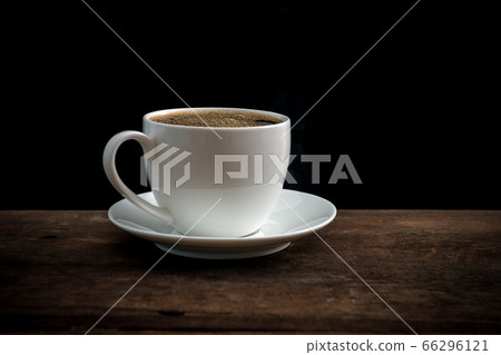 Cup of coffee on old wooden table Cup of coffee on old wooden table 66296121