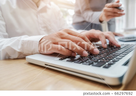 Business team brainstorming and discussing with financial data and report graph. 66297692