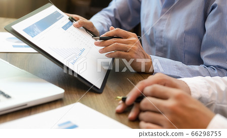 Business team brainstorming and discussing with financial data and report graph. Business team brainstorming and discussing with financial data and report graph. 66298755