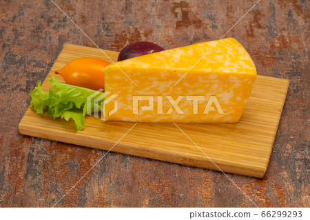 Marble cheese triangle over wooden Marble cheese triangle over wooden 66299293