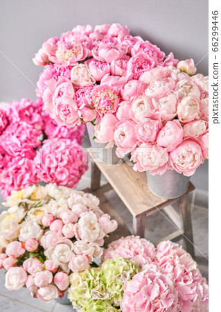vases with peonies for Flowers delivery. Pink Angel Cheeks peonies in a metal vase. Beautiful peony flower for catalog or online store. Floral shop concept . 66299446