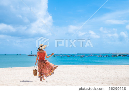 Woman in the summer sea 66299618