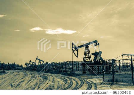 Petroleum concept. Oil pump rig. Oil and gas production. Oilfield site. Pump Jack are running. Drilling derricks for fossil fuels output and crude oil production. Global crisis. War on oil prices. Petroleum concept. Oil pump rig. Oil and gas production. Oilfield site. Pump Jack are running. Drilling derricks for fossil fuels output and crude oil production. Global crisis. War on oil prices. 66300498