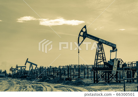 Petroleum concept. Oil pump rig. Oil and gas production. Oilfield site. Pump Jack are running. Drilling derricks for fossil fuels output and crude oil production. Global crisis. War on oil prices. 66300501