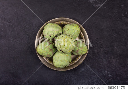 Pile of green Spanish or Italian Artichokes on the 66301475