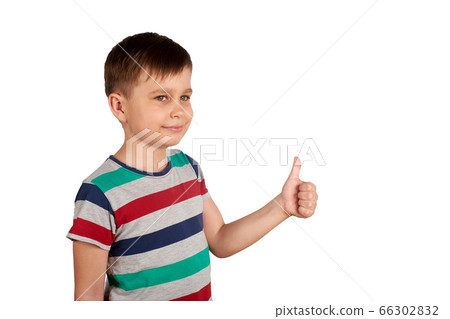 Portrait of attractive young boy, smiling showing thumbs up, on white background. Copy space Portrait of attractive young boy, smiling showing thumbs up, on white background. Copy space 66302832