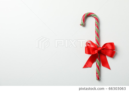 Sweet candy cane with bow on white background, Sweet candy cane with bow on white background, 66303063