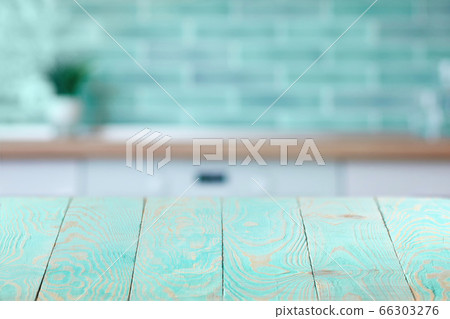 Wooden textured blue table on a background of blurred interior. 66303276