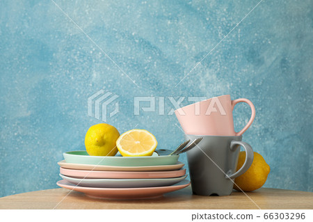 Plates and cups with lemons stacked on wooden Plates and cups with lemons stacked on wooden 66303296