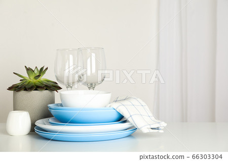 Cutlery with succulent plant stacked on white Cutlery with succulent plant stacked on white 66303304