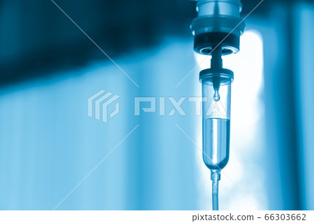 Saline iv bag intravenous drip hospital room,Medical Concept,treatment and injection vitamin natural drug infusion care chemotherapy concept.green light background hospital,Selective focus 66303662