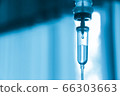 Saline iv bag intravenous drip hospital room,Medical Concept,treatment and injection vitamin natural drug infusion care chemotherapy concept.green light background hospital,Selective focus 66303663