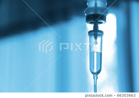 Saline iv bag intravenous drip hospital room,Medical Concept,treatment and injection vitamin natural drug infusion care chemotherapy concept.green light background hospital,Selective focus Saline iv bag intravenous drip hospital room,Medical Concept,treatment and injection vitamin natural drug infusion care chemotherapy concept.green light background hospital,Selective focus 66303663