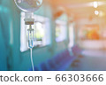 Saline iv bag intravenous drip hospital room,Medical Concept,treatment and injection vitamin natural drug infusion care chemotherapy concept.green light background hospital,Selective focus 66303666