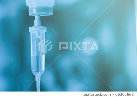 Saline iv bag intravenous drip hospital room,Medical Concept,treatment and injection vitamin natural drug infusion care chemotherapy concept.green light background hospital,Selective focus 66303668