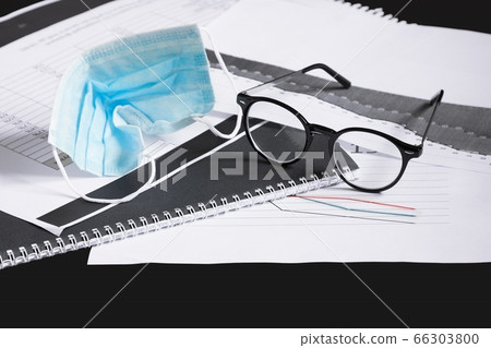 New rule. Need to wear mask in workplace. Used crumpled medical mask, glasses on chart. New rule. Need to wear mask in workplace. Used crumpled medical mask, glasses on chart. 66303800