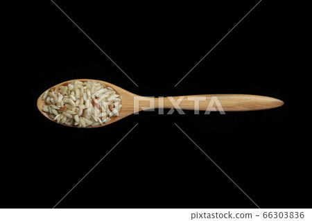 Pile of brown rice with spoon isolated on Black Pile of brown rice with spoon isolated on Black 66303836