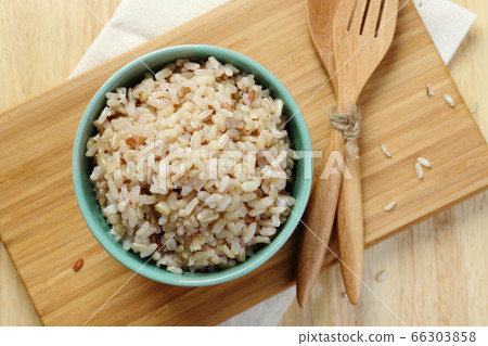 Brown Rice on Wooden Plate Brown Rice on Wooden Plate 66303858
