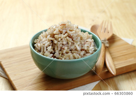 Brown Rice on Wooden Plate Brown Rice on Wooden Plate 66303860