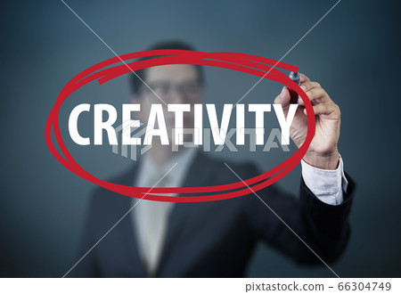 Businessman hand writing "Creativity" with red 66304749