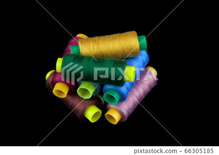 Coloured thread isolated on black background 66305185