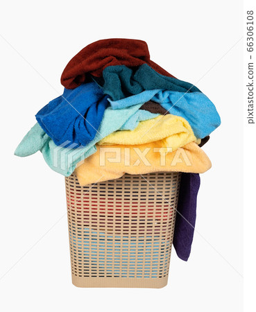 Laundry basket with a pile of towels isolated on Laundry basket with a pile of towels isolated on 66306108