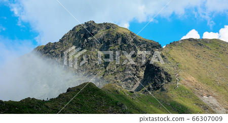 high mountain peaks among the clouds. wonderful 66307009