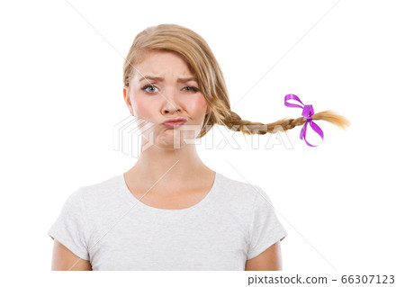 Teenage girl in braid hair making funny face 66307123
