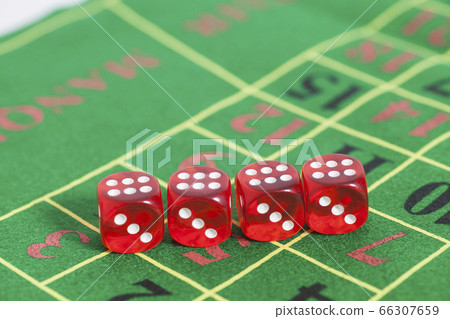 roll of the red dice on a game table in a casino 66307659