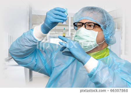 The doctor takes the medication from a bottle The doctor takes the medication from a bottle 66307868