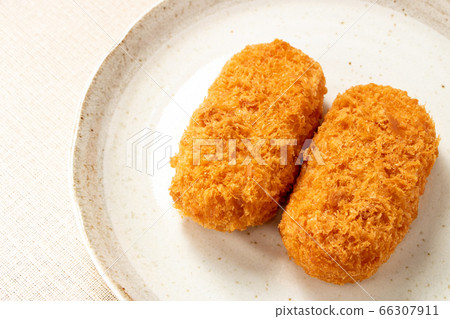 Two bale-shaped cream croquettes placed on a plate. Two bale-shaped cream croquettes placed on a plate. 66307911