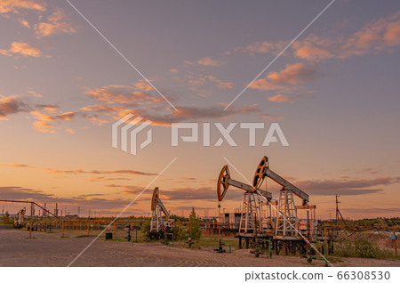 Petroleum concept. Oil pump rig. Oil and gas production. Oilfield site. Pump Jack are running. Drilling derricks for fossil fuels output and crude oil production. Global crisis. War on oil prices. Petroleum concept. Oil pump rig. Oil and gas production. Oilfield site. Pump Jack are running. Drilling derricks for fossil fuels output and crude oil production. Global crisis. War on oil prices. 66308530