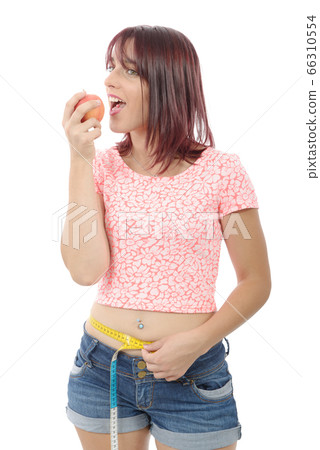 Young woman eating apple, isolated on white Young woman eating apple, isolated on white 66310554