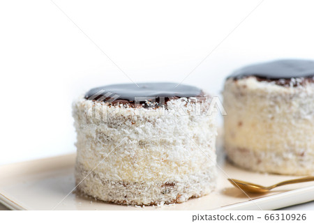 Homemade coconut cake with chocolate on a plate 66310926