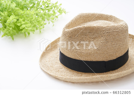 Straw hat placed on a white table Straw hat placed on a white table 66312805