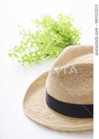 Straw hat placed on a white table 66312813