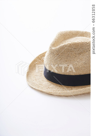 Straw hat placed on a white table 66312858
