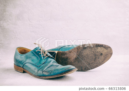 Pair of old leather blue discarded boots with laces Pair of old leather blue discarded boots with laces 66313806