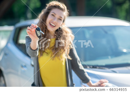 Keys to the new car in the girls hand. 66314935