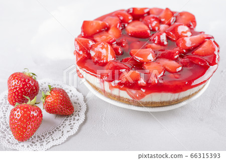 cheesecake with strawberry and fresh berries on gray table cheesecake with strawberry and fresh berries on gray table 66315393