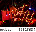 Red neon lettering on a contrasting black background. And colorful light bulbs 66315935